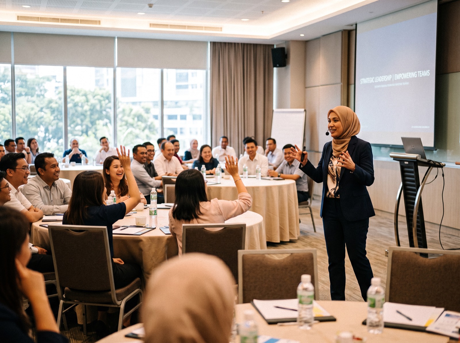 A PeopleLab trainer addressing a full training hall