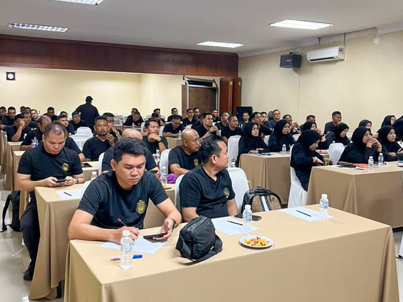 A large corporate audience attending a training session