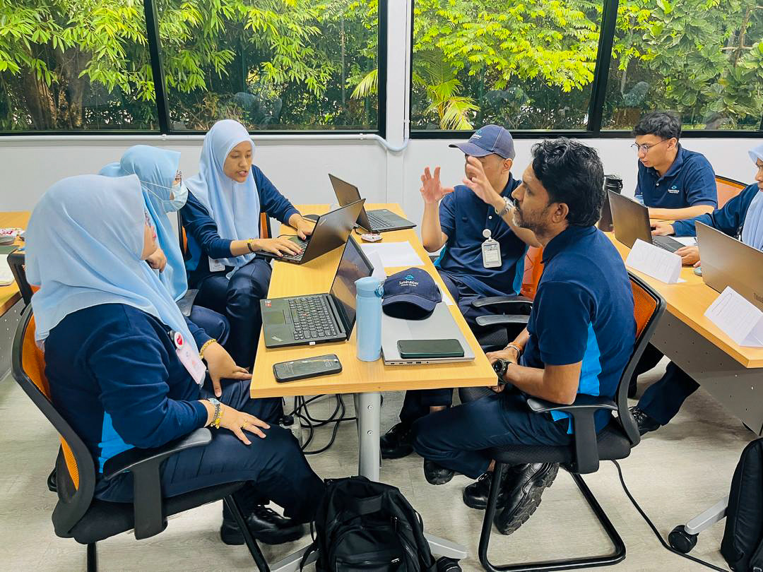 A team working through a compliance exercise together