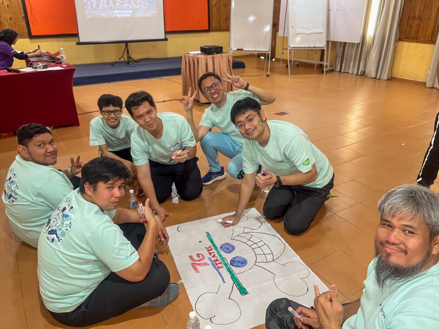 A team painting their team flag together